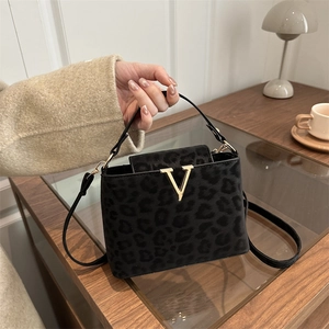 Fashionable black leopard print square handbag with gold V-shaped metal buckle and strap