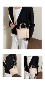 Detail view of nylon mini tote bag with adjustable strap and top zipper in beige