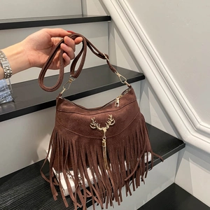 Brown suede tassel shoulder bag with golden stag head hardware and bohemian fringe design