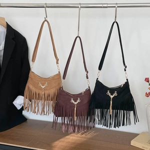 Three bohemian suede tassel crossbody bags in khaki, black, and brown with gold deer accents