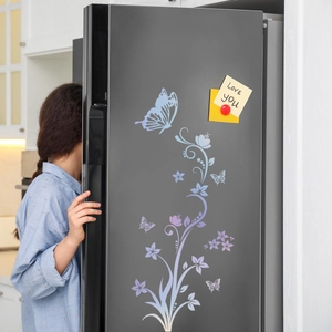 Luminous floral vine and butterfly wall stickers on a premium black refrigerator surface