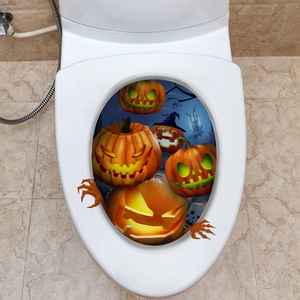 Halloween Jack-O-Lantern stickers and orange monster claws on a white toilet lid