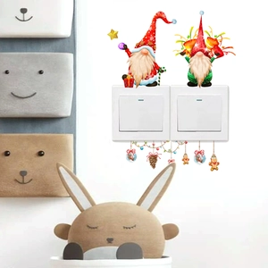 Detailed view of Christmas gnome wall stickers around a light switch with festive stars