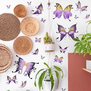 Detailed view of purple and gold butterfly wall stickers in a cozy home interior setting