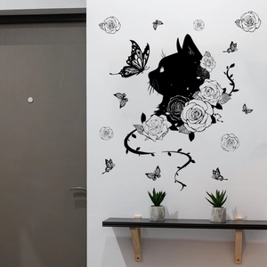 Detail of black cat and rose wall stickers applied on a white living room wall