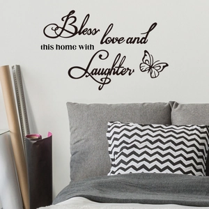 Detail view of Bless this home wall sticker with butterflies in a modern bedroom setting