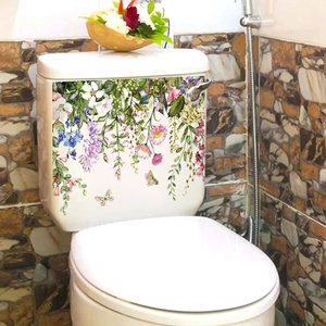 Detailed view of self-adhesive watercolor floral and butterfly stickers on a toilet tank