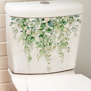 Watercolor green eucalyptus and rose floral stickers on a white ceramic toilet tank