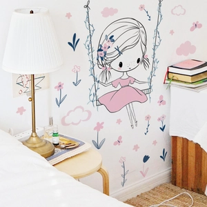 Nursery wall sticker detail showing a cartoon girl on a swing with flowers and butterflies