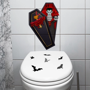 Close-up of Halloween vampire wall sticker and black bat decals on a white toilet lid
