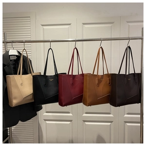 Selection of large leather tote bags in five colors with slim handles and metal logo