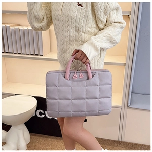 Close-up of lavender quilted 14-inch laptop bag with pink handles and triangular zippers