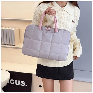 Detailed close-up of quilted lavender laptop bag with pink handle and triangle zipper pull