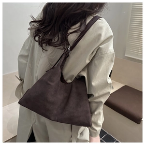 Detailed view of the dark brown suede tote bag showing its rich matte texture and drape