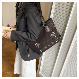 Macro detail of dark brown cat-shaped tote bag in premium matte leather texture