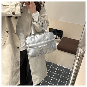 Metallic silver hobo bag with bow detail shown in a mirror selfie for size reference