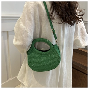 Vue détaillée d'un sac à main vert vif à paillettes avec poignée circulaire évidée