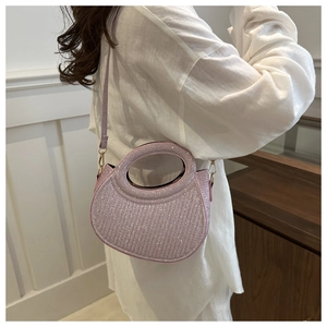Close-up of a lilac sequins handbag with a round handle and adjustable shoulder strap