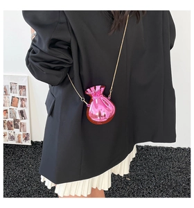 Chic pink mirror-finish mini candy bag with gold chain strap shown on fashion model