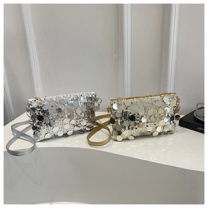 Macro shot of silver and gold sequined bags showing reflective round sequins and metal zipper