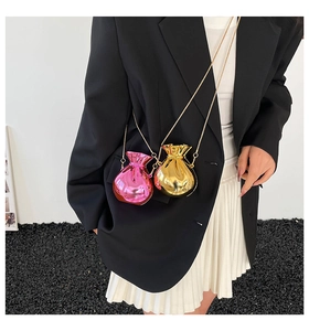 Detail of pink and gold acrylic money bag mini cross-body purses with chain straps