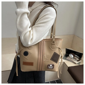 Close-up of beige tote bag with vintage embroidery patches and large storage capacity