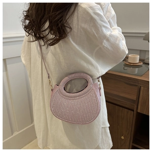 Detailed view of mini pink sequined semi-circle handbag with golden hardware