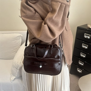 Retro chocolate brown glossy leather underarm bag with bow and heart charm details