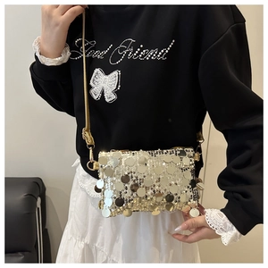 Detail of silver and gold sequins on a mini square crossbody bag with metal chain strap