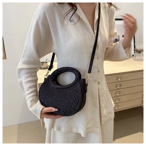 Detail of black glitter crossbody bag with hollow round handle and vertical pleats texture