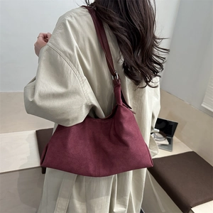 Retro burgundy faux suede tote bag shown on model for a stylish oversized shoulder look
