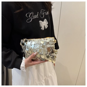 Gros plan détaillé d'un sac de soirée à paillettes argent champagne avec zip en métal