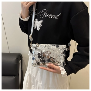 Detail of silver sequin mini shoulder bag with large mirror discs and gold hardware
