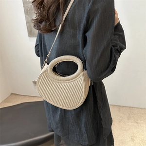 Champagne gold crescent woven handbag with circular handle and detachable shoulder strap
