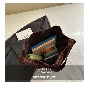 Top view of leopard print tote bag interior showing large capacity for laptop and umbrella