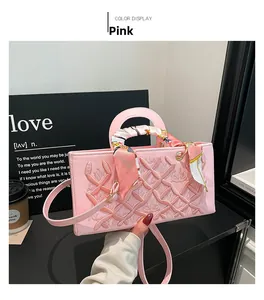 Detail of pink embroidered handbag with crown pattern and silk scarf wrapped handle