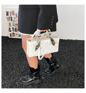 White embroidered crossbody bag with patterned silk scarf handle and metal ring accents