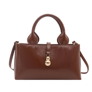 Vintage brown leather bucket handbag for women with unique gold calabash ornament