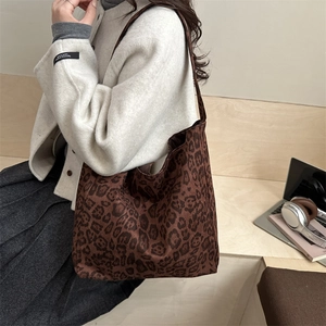 Deep brown leopard print knit tote bag for women shown as a stylish large shoulder bag