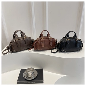 Detailed trio view of vintage leather mini bags in grey, brown, and black with metal studs