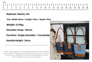 Detail view of denim bucket bag with brown leather trim and golden square buckle