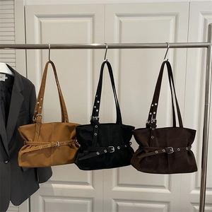 Vintage suede shoulder bags with decorative belts in caramel, black, and brown