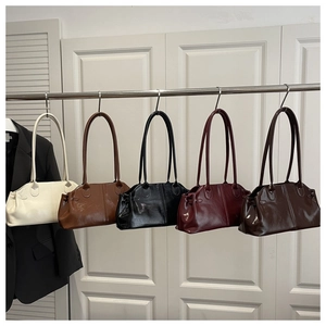 Minimalist PU leather underarm shoulder bags in five colors hanging on display