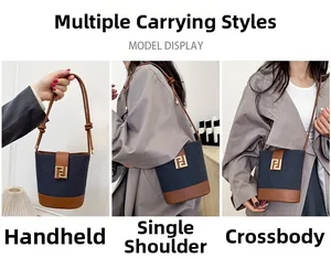 Three-way carry display of denim and leather bucket bag: tote, shoulder, and crossbody