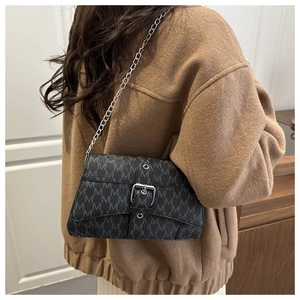 Detail of black chain strap shoulder bag with M-letter print and silver buckle detail