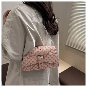 Detailed close-up of pink chain bag featuring monogram M patterns and silver metal buckle