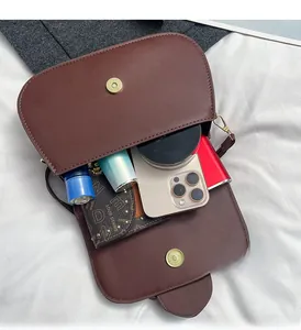 Detailed view of the brown crossbody bag interior showing spacious storage capacity