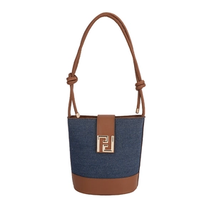 Chic denim and brown leather bucket bag with gold geometric buckle and knotted strap