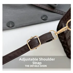 Detail of woven texture dark brown bag with adjustable strap and golden hardware