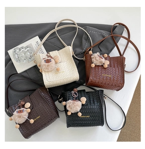 Detailed view of vintage woven bucket bags in four colors with plush charms